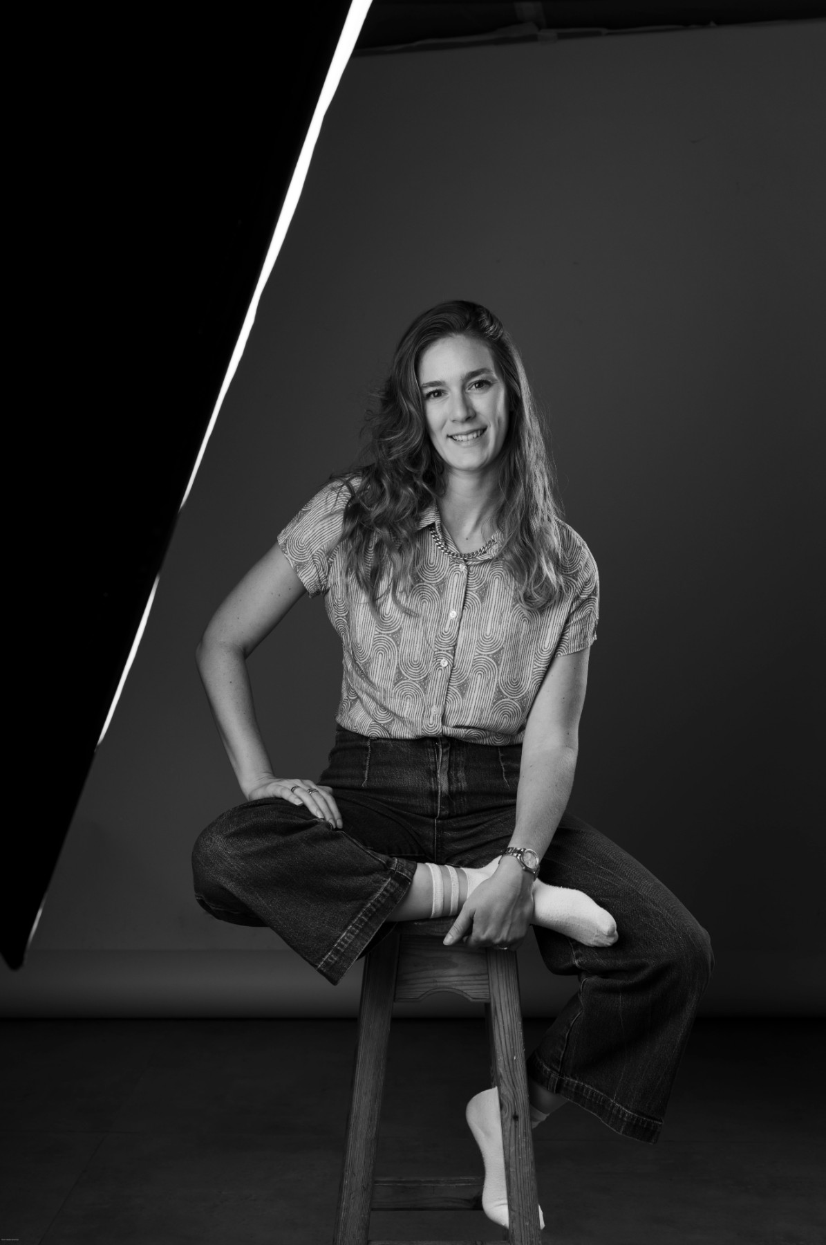 Naama Rubenchik seated on a stool in the studio