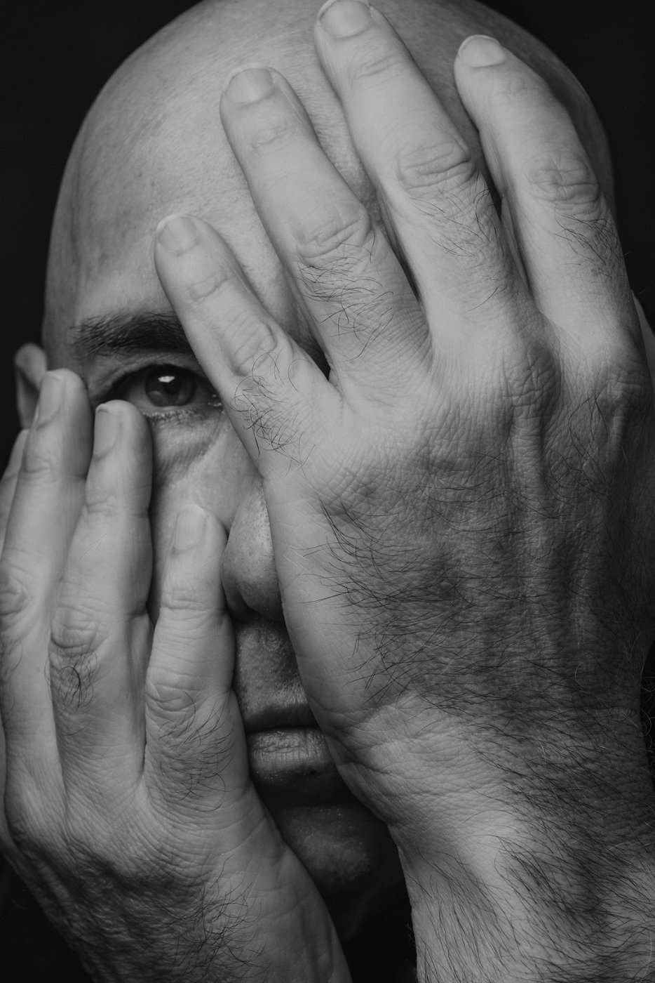 Portrait, hands over face